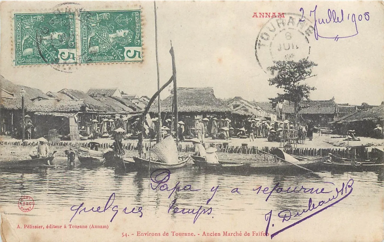 Old postcard of the former market of Faifoo on the riverbank, rows of thatched roofs with boats moored in front