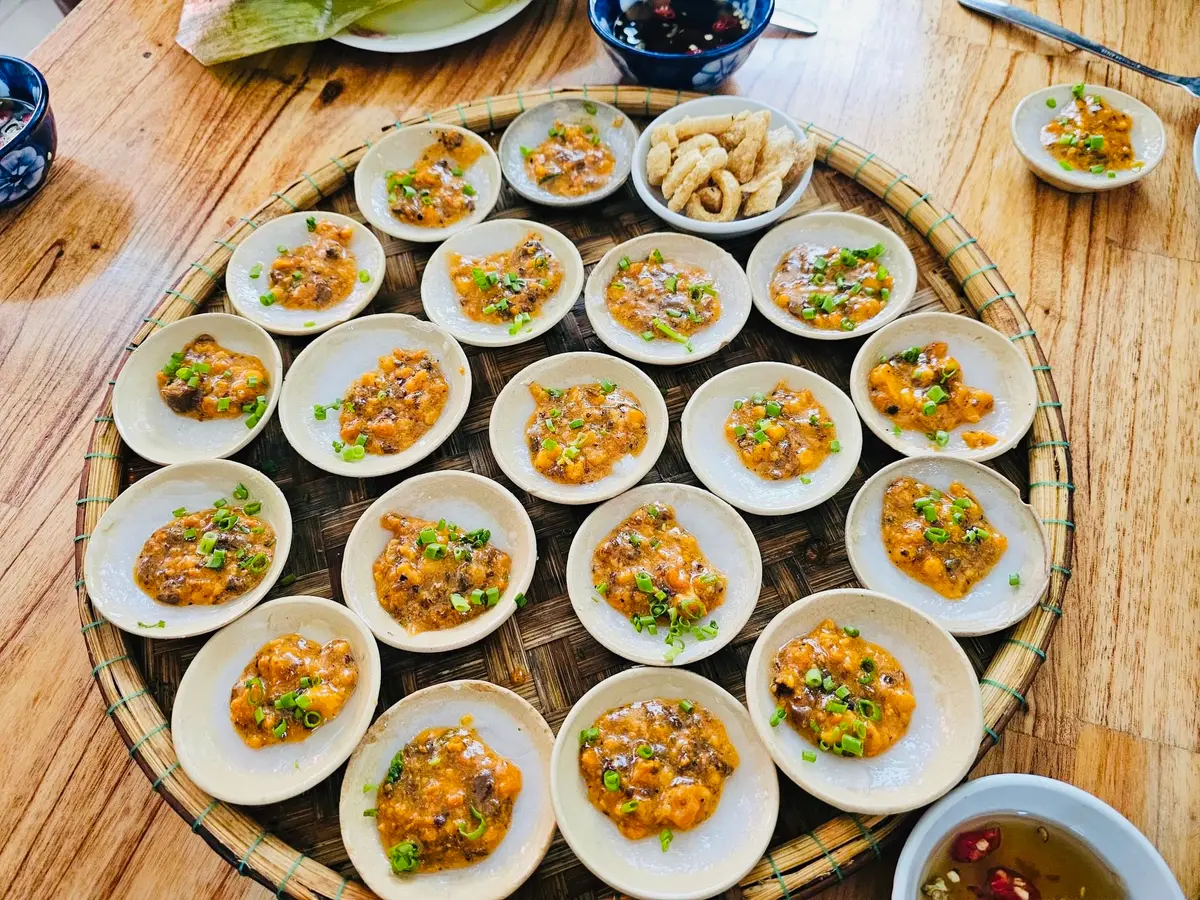 Round tray filled with bowls of banh beo at Be Loan, Da Nang